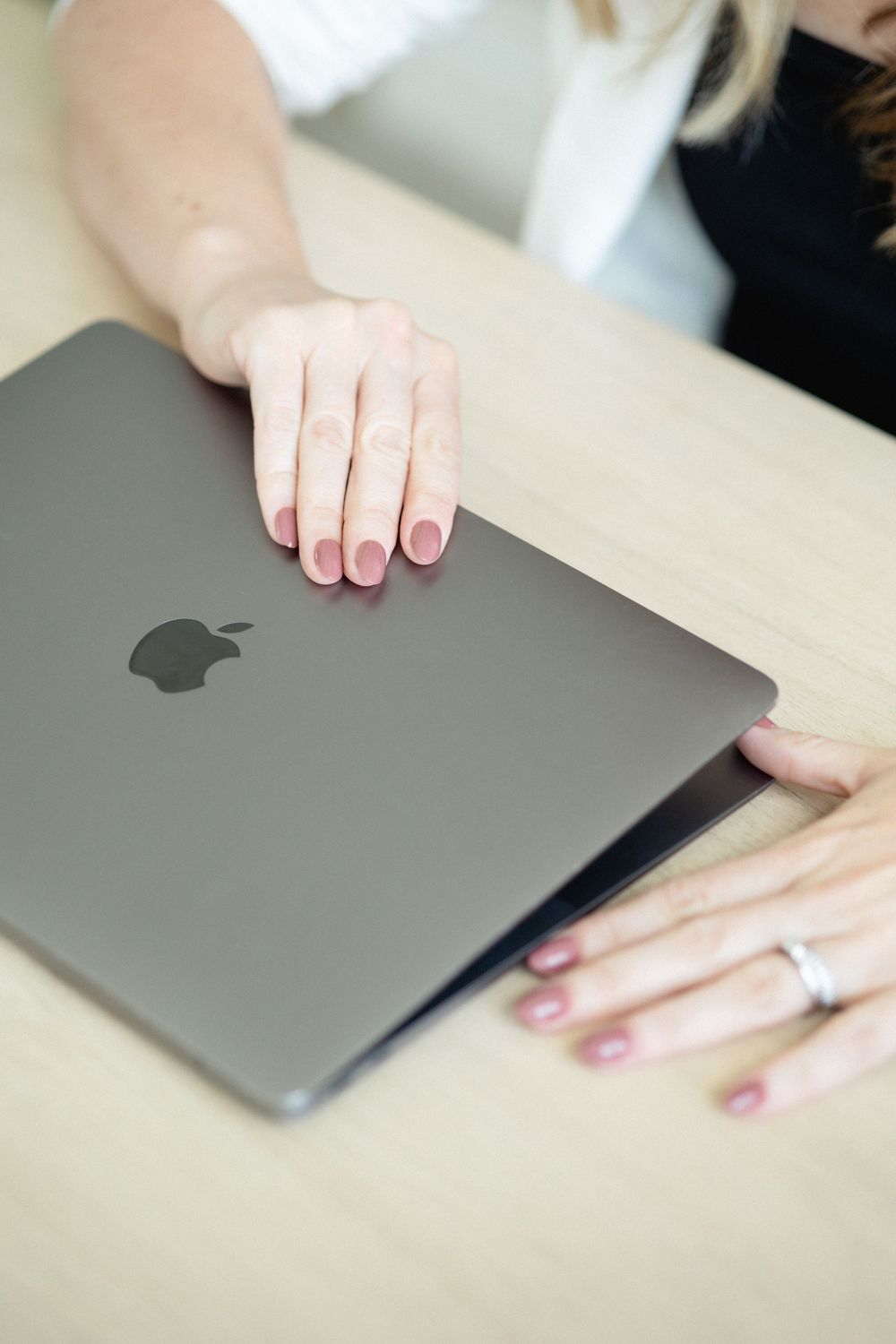 opening Mac laptop with light pink coloured nails during a branding photography session