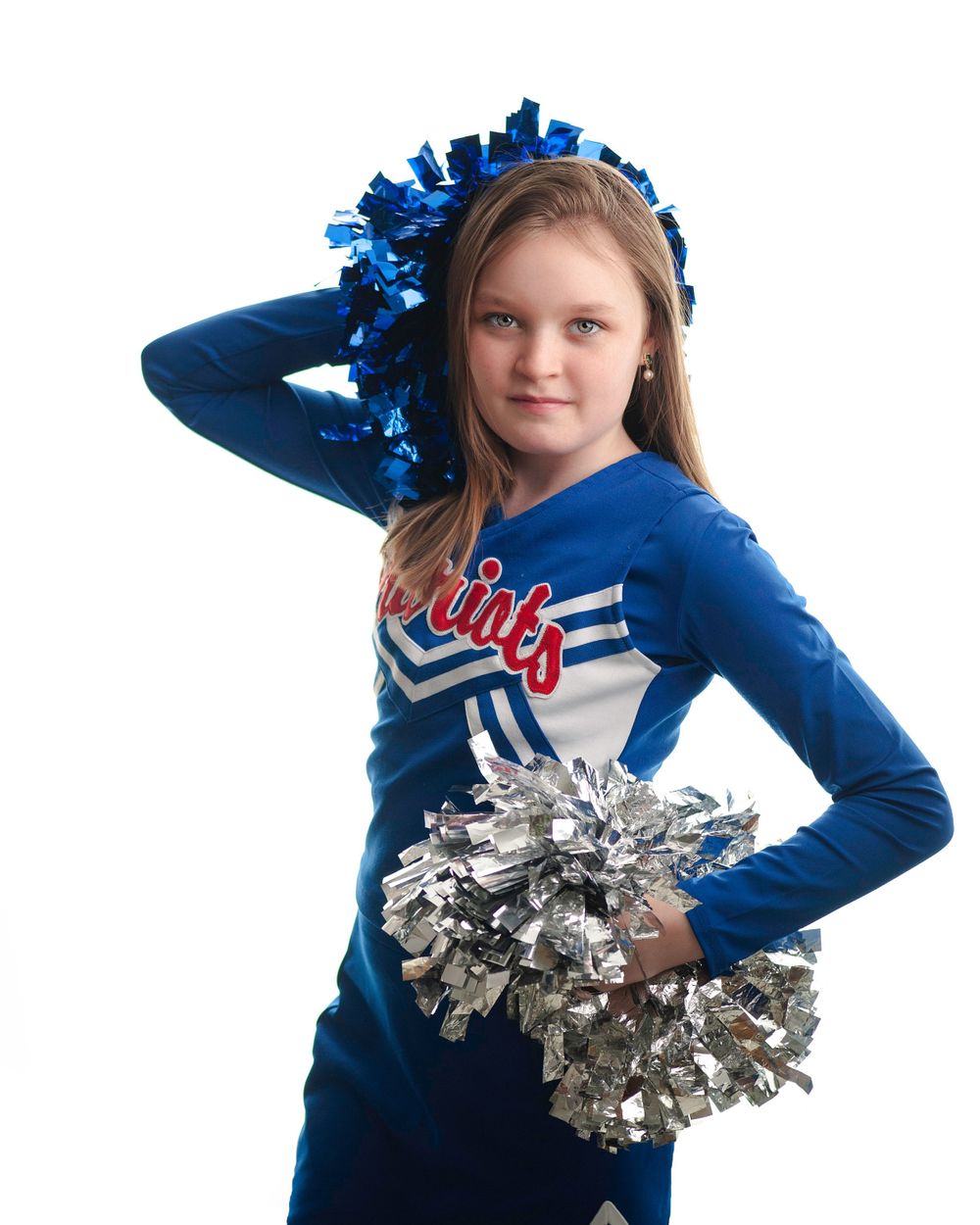 Young female cheerleader posing on a white backdrop.