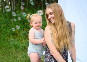Beautiful moment captured with bubbles floating in a lush garden setting.