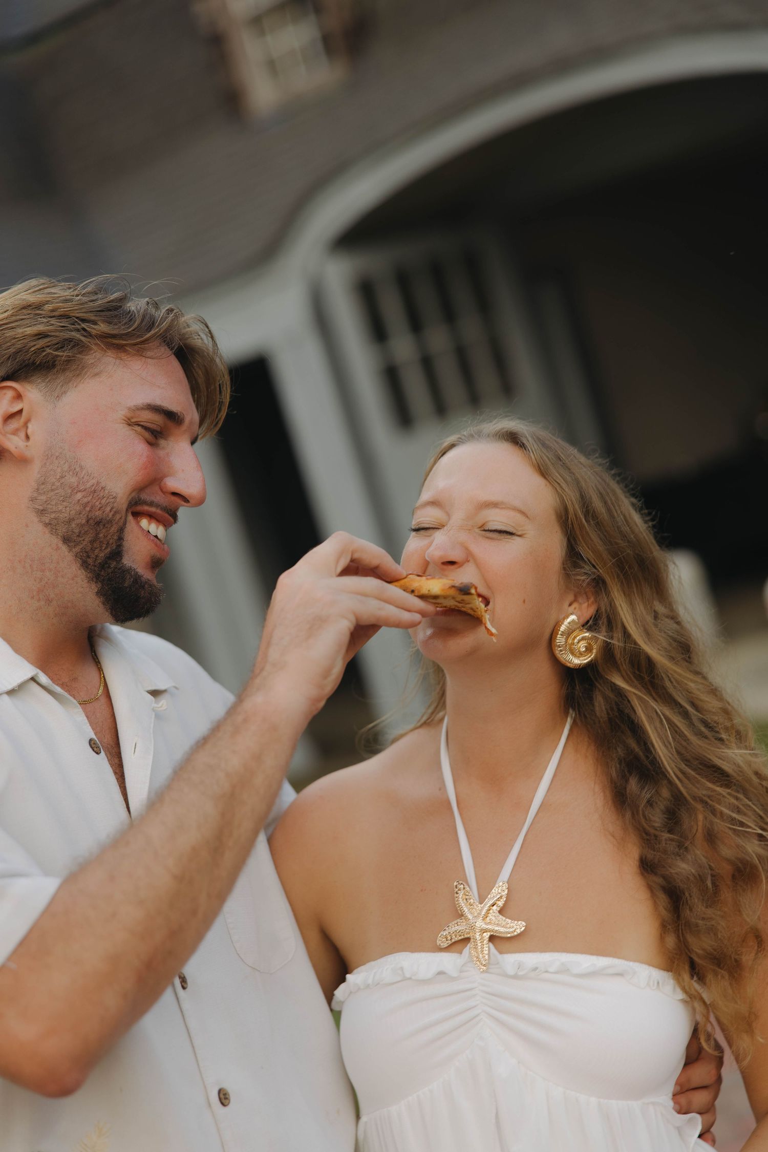 A romantic wedding portrait on grand stone steps of a historic building.