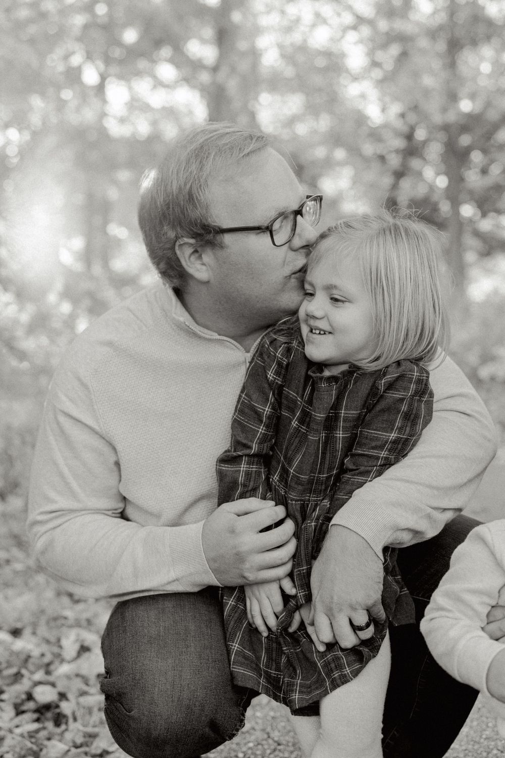 Black and white intimate family moments captured during an outdoor photo session.
