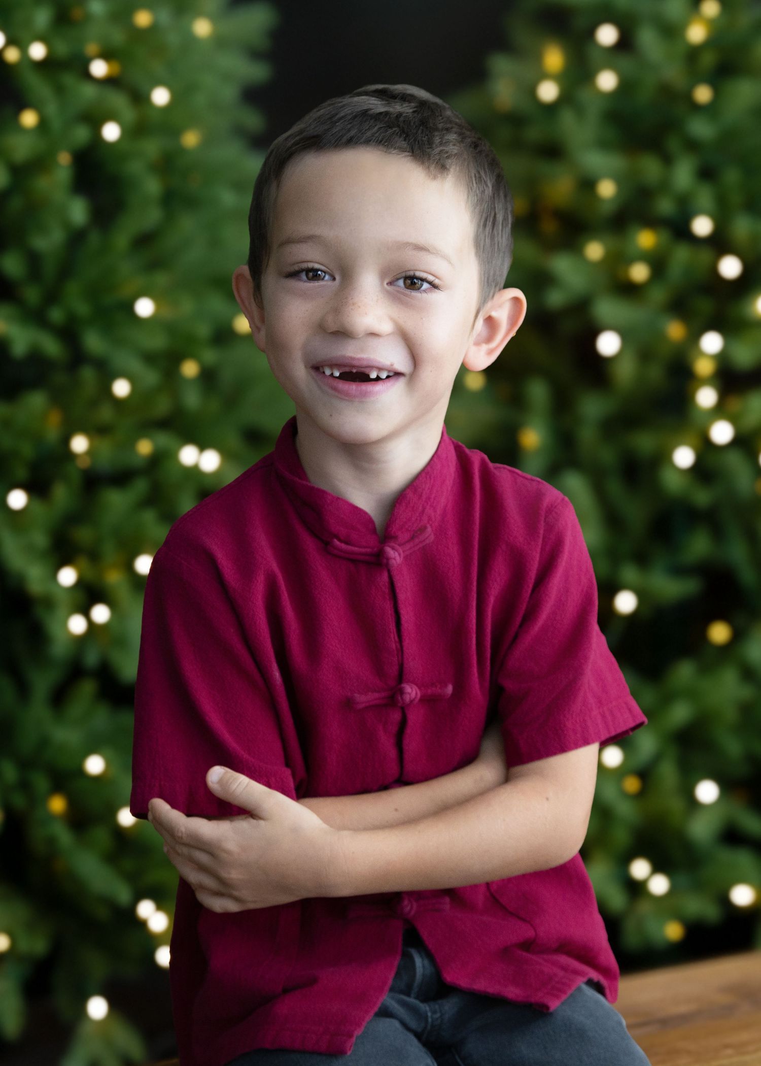 Hong Kong Christmas Family photo shoot portrait of a boy in front of a Christmas tree with bokeh fairy lights