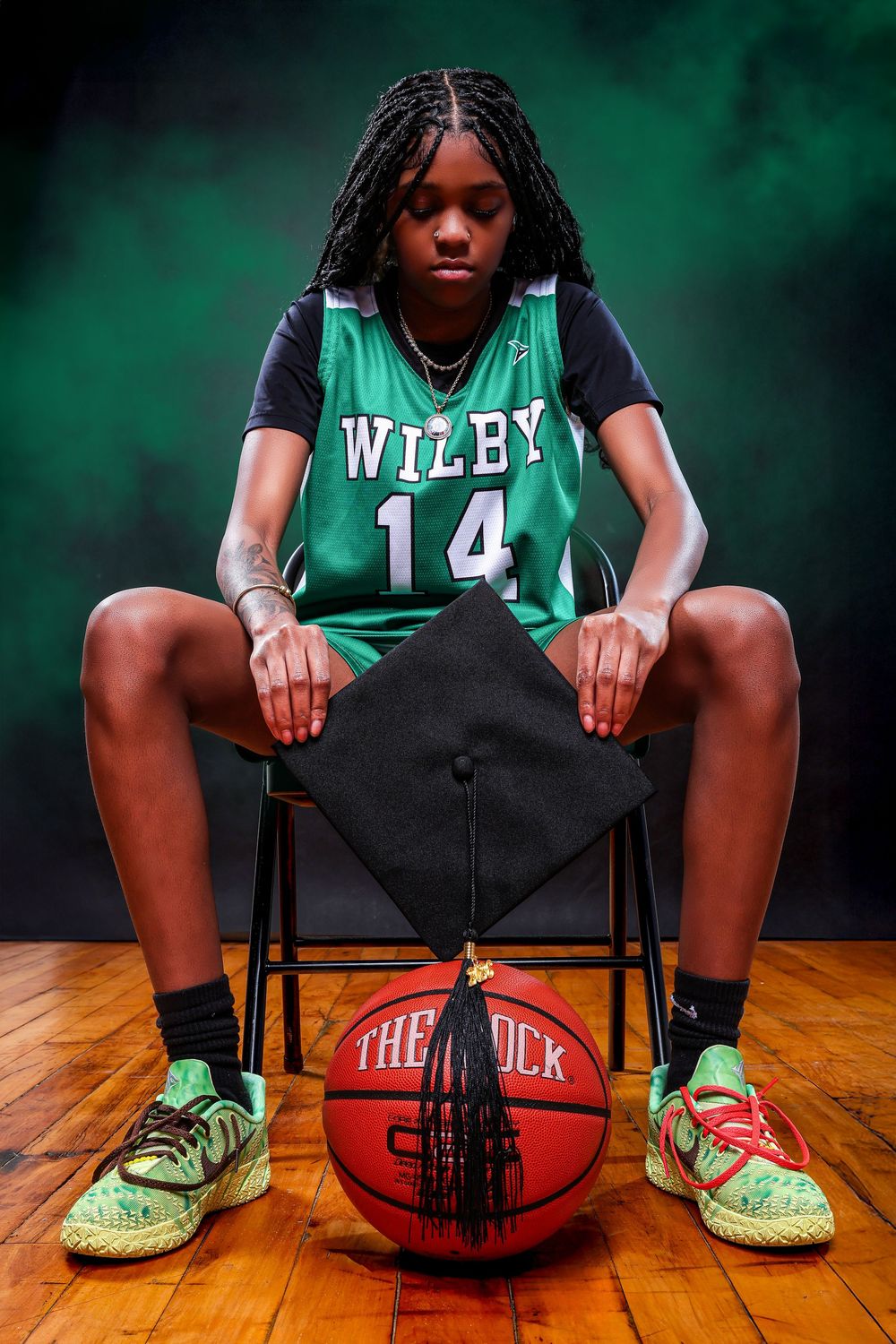 Basketball-themed senior photo featuring Wiley jersey number 14 with a basketball on wooden court.