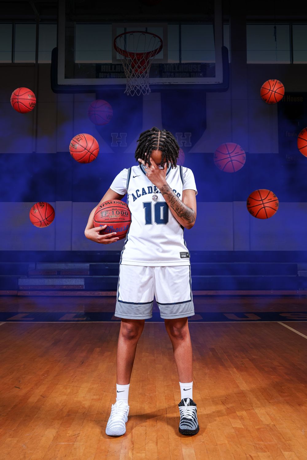 Multiple basketballs float against a dark blue background in a basketball court setting with hardwood floors.