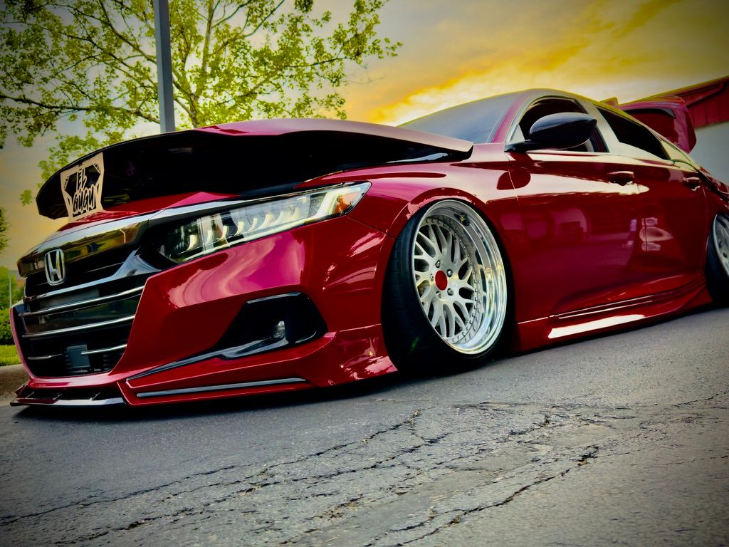 Heavily modified slammed red Honda Accord with wide-body kit and BBS wheels.