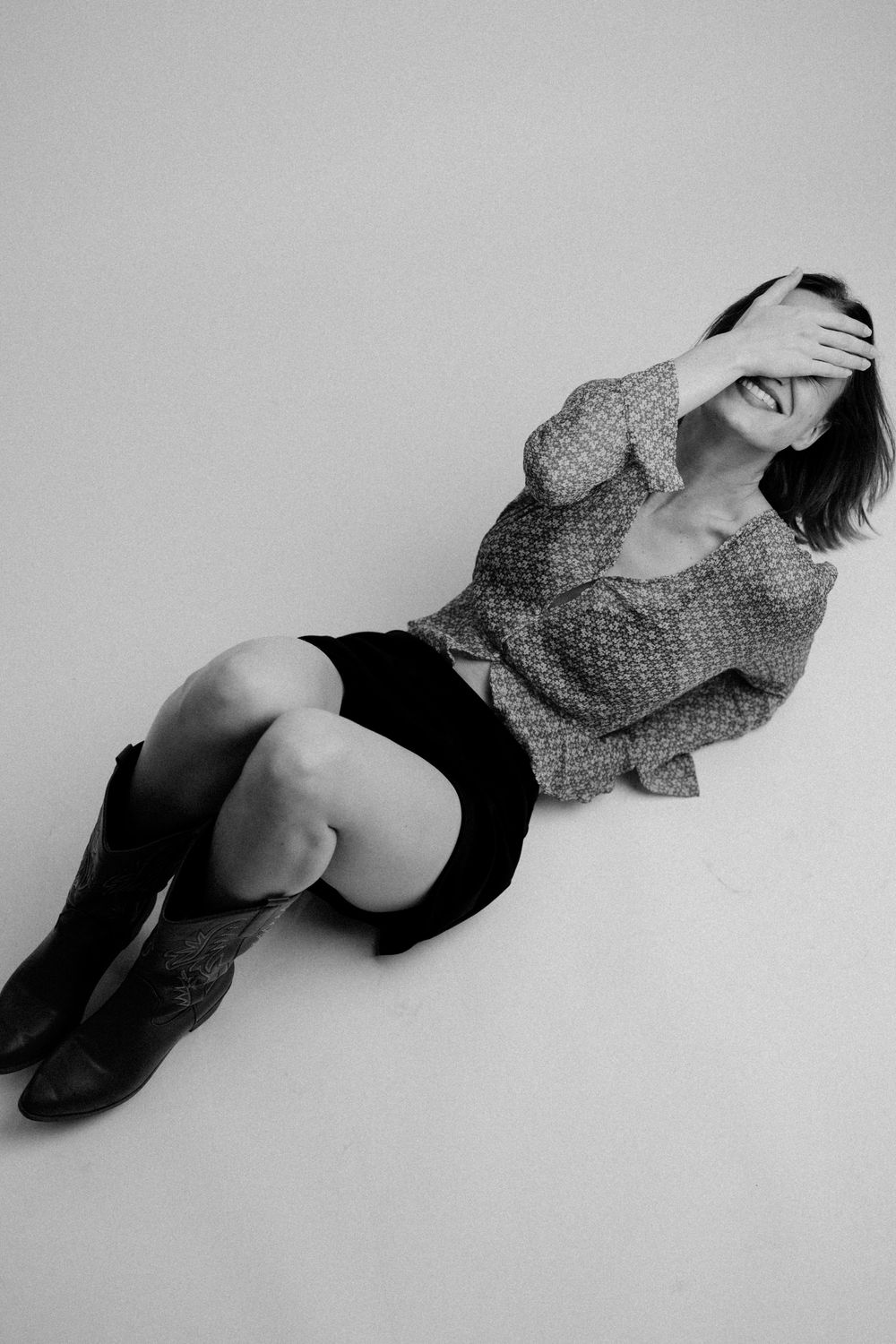 A black and white artistic photo series showing a person in polka dot clothing lying down in different dramatic poses.
