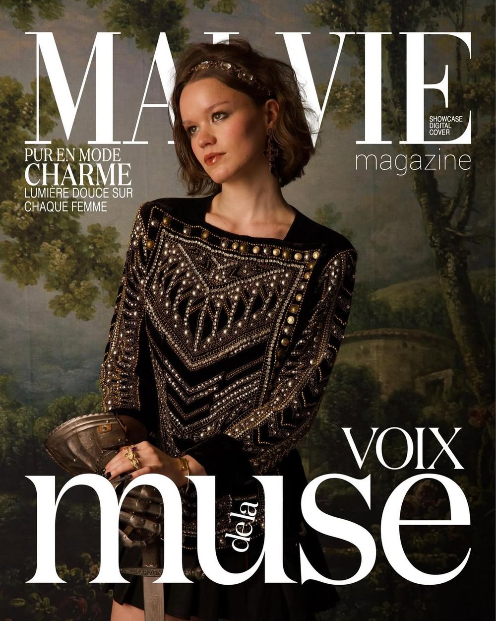 Fashion magazine cover featuring a model in an elegant black beaded dress against a moody forest backdrop.
