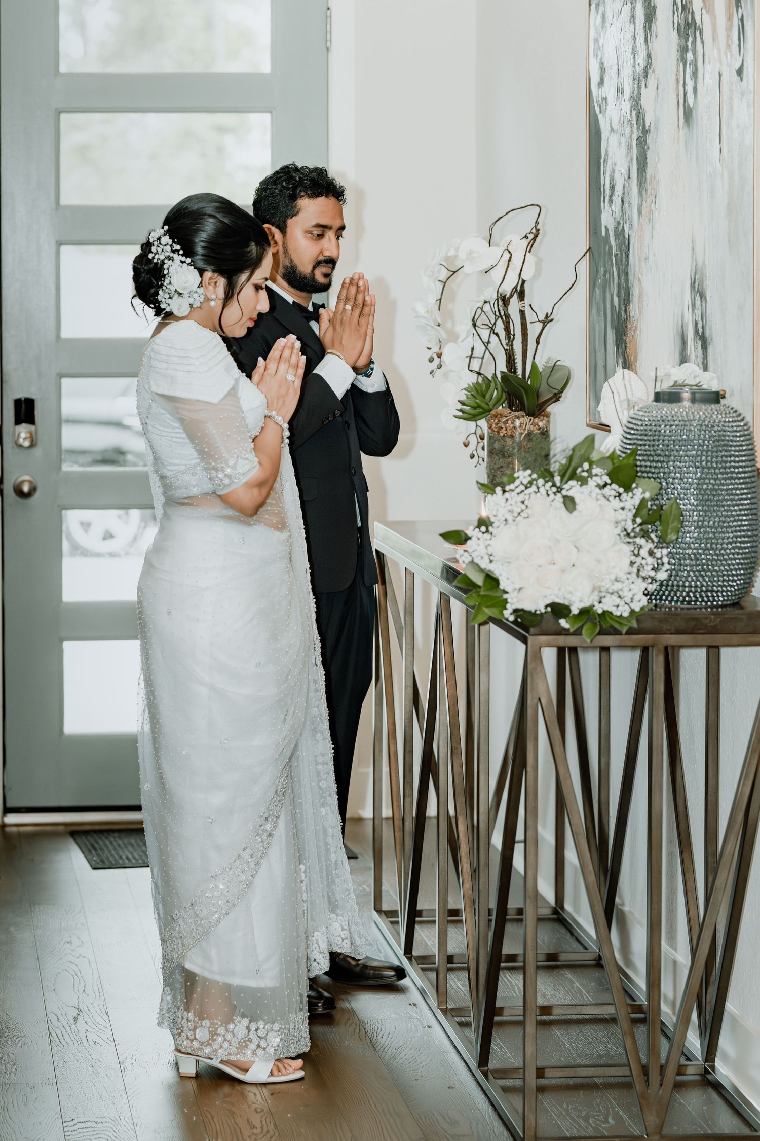 An intimate first look moment between newlyweds in a modern white interior setting.