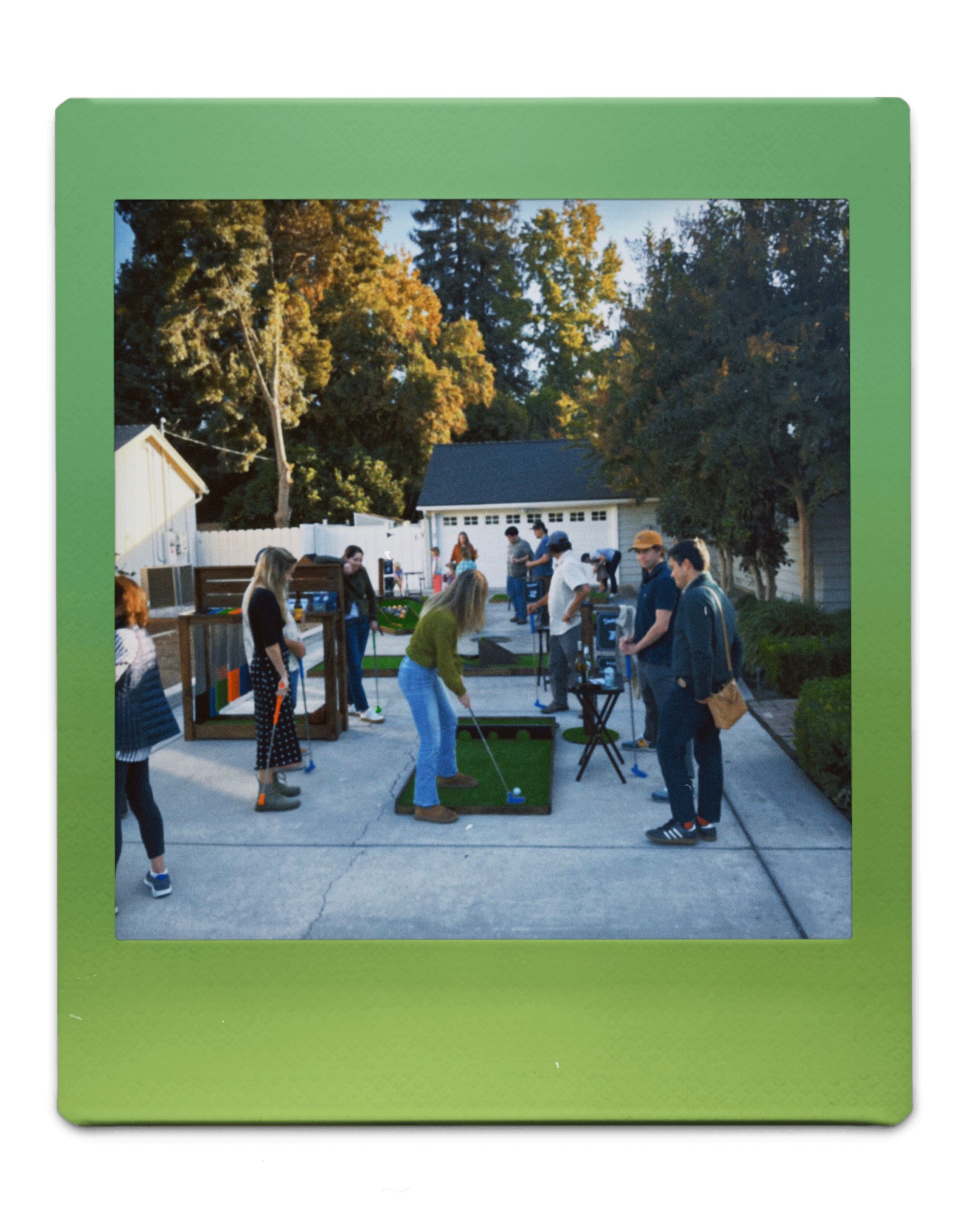 A group of people playing mini golf on a patio area during an outdoor gathering in Fresno, CA.