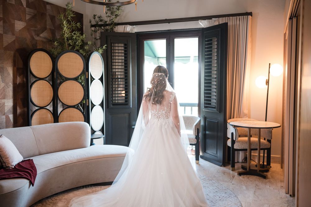 Groom suit hanging by arched window at Hotel El Convento wedding