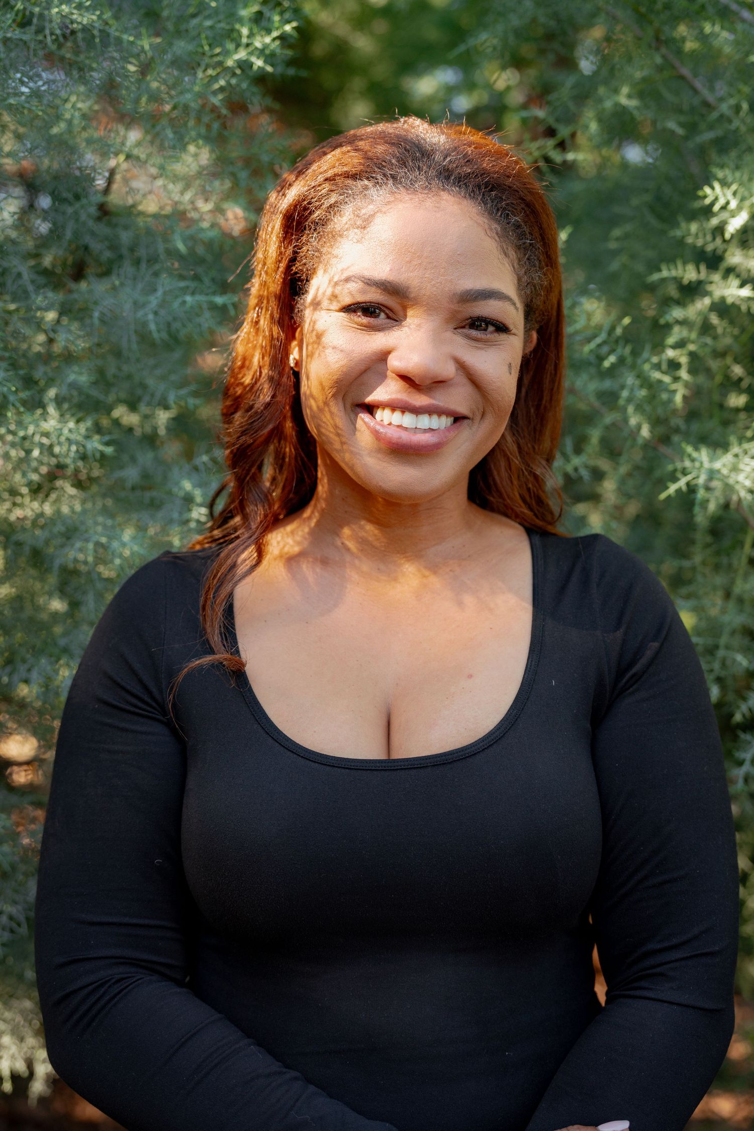 A series of six photos showing someone wearing a black long-sleeved top against a green outdoor background.