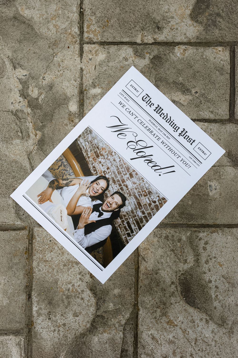 Wedding photographs scattered on a concrete or stone surface showing elegant black and white portrait prints.