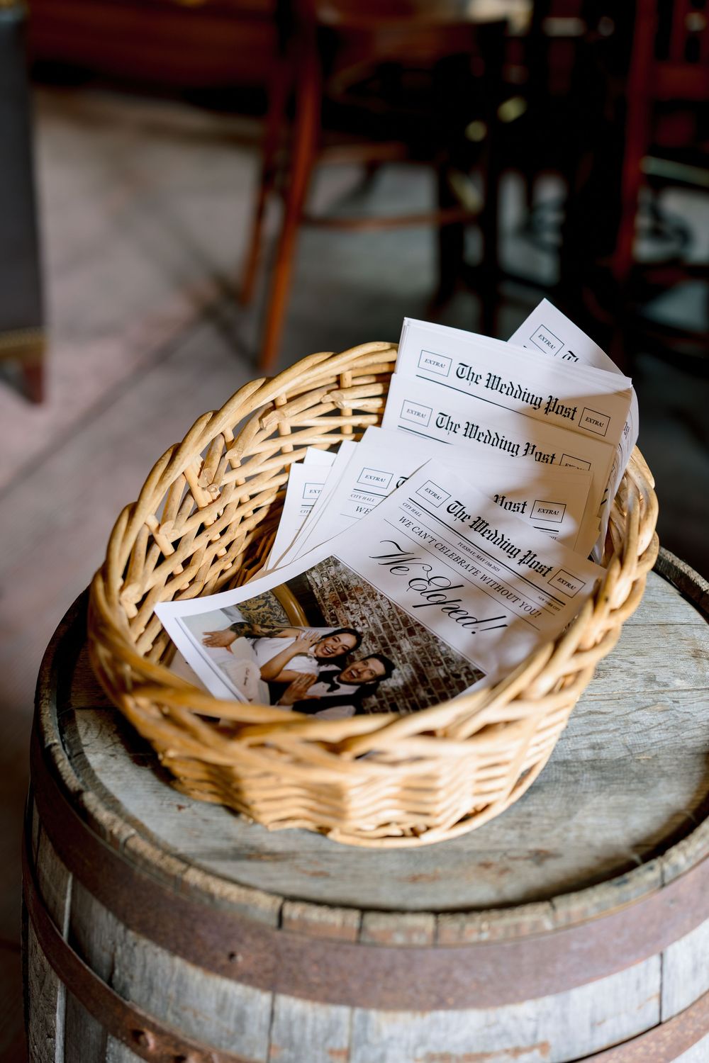 A sequence of images showing a newspaper being burned in a wicker basket on top of a wooden barrel.