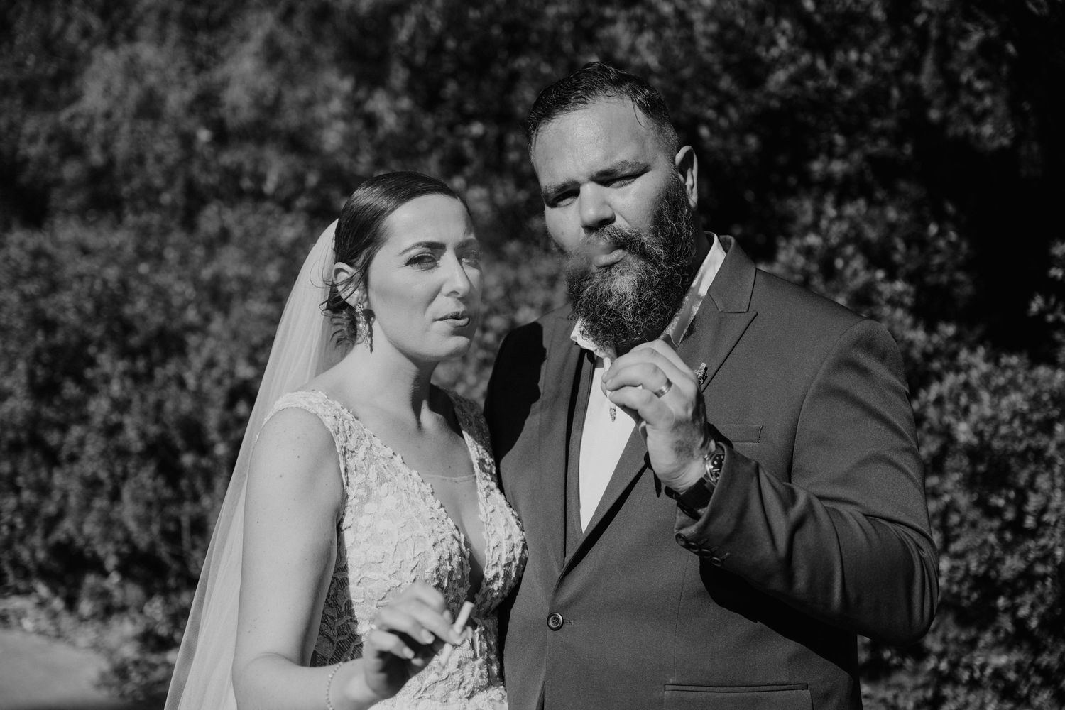 A romantic black and white photo series showing tender moments between a couple on their wedding day.