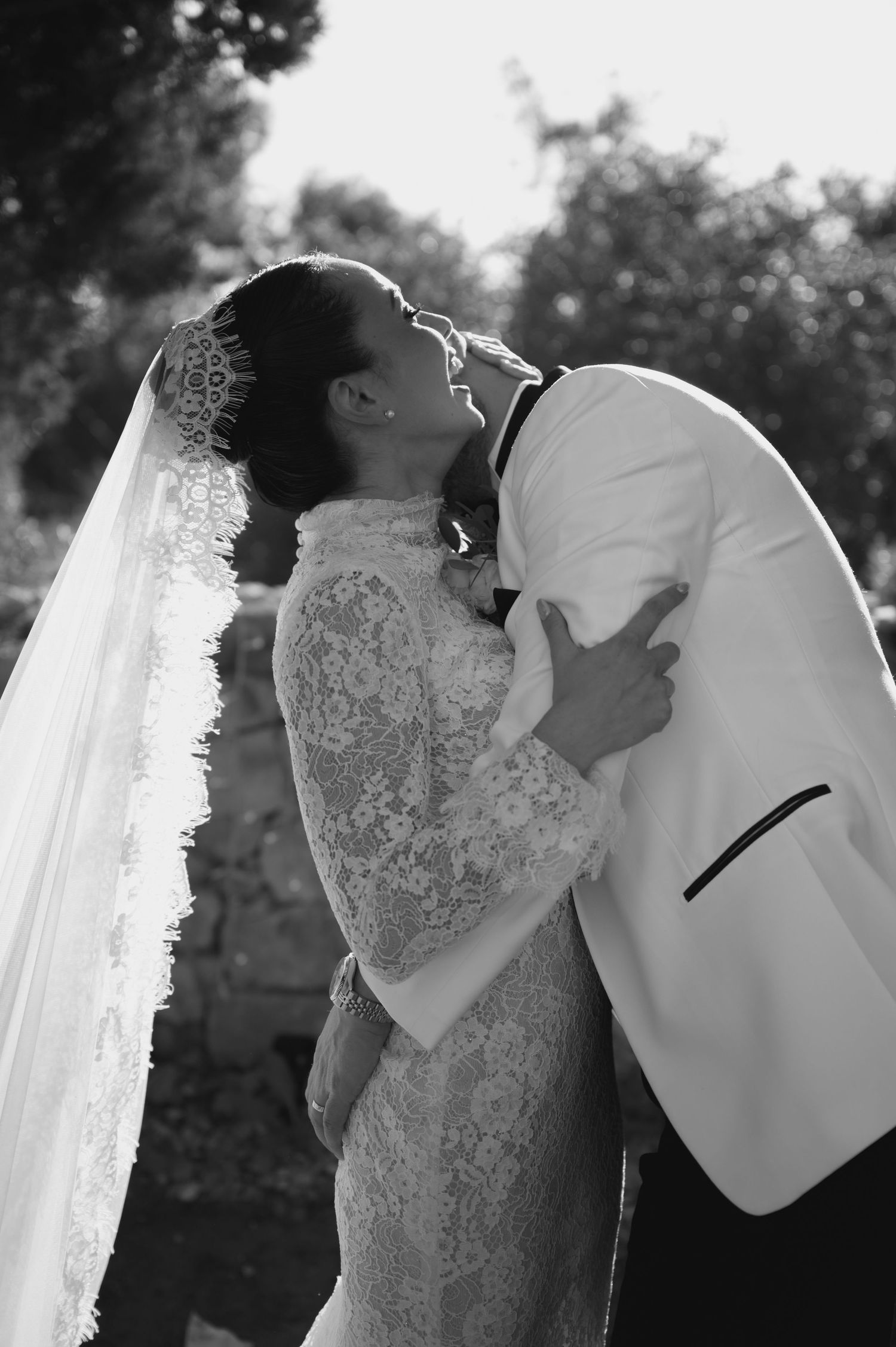 A romantic black and white photo sequence shows a couple in wedding attire sharing intimate moments outdoors.
