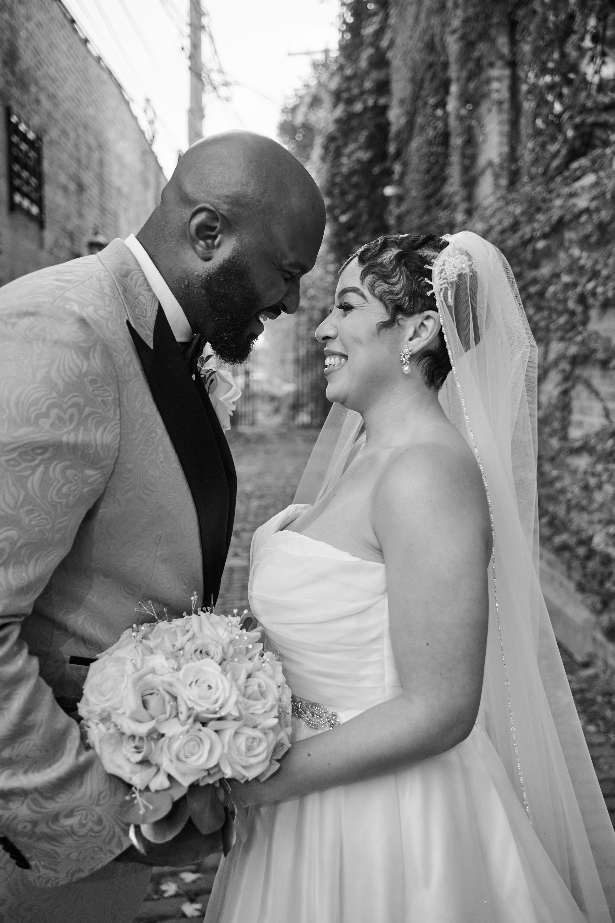 A romantic black and white wedding photo collage showing tender moments between newlyweds with white roses.