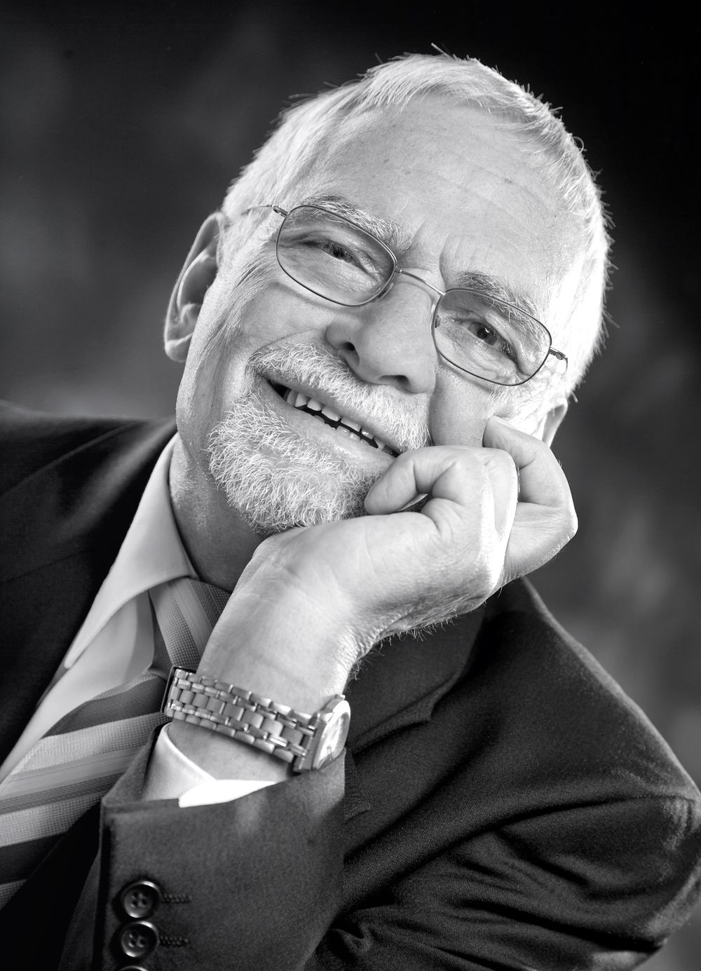 A series of black and white photographs showing joyful expressions and laughter in a professional setting.