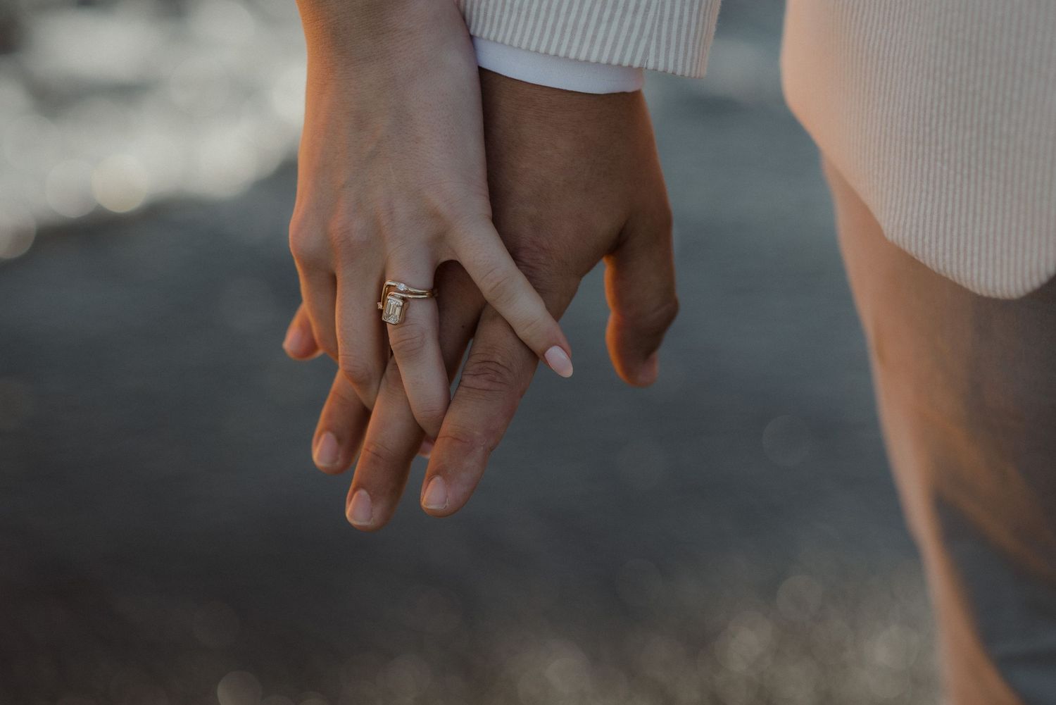 Close-up shot of hands exchanging wedding rings during an intimate ceremony.