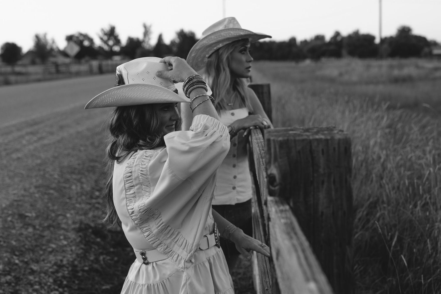 Black and white photos of a couple in vintage clothing dancing and embracing in a rural field setting.