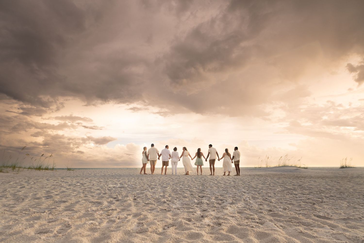 A Family walks along a peaceful beach at sunset with waves crashing on the shore Lido beach Photographer