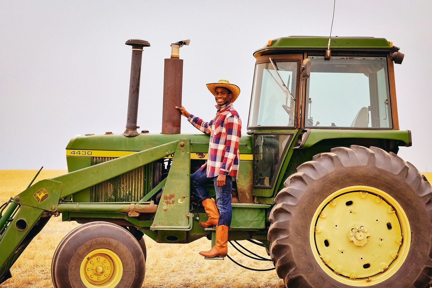 A series of five connected photos showing a John Deere tractor in different angles and positions in a farm field.