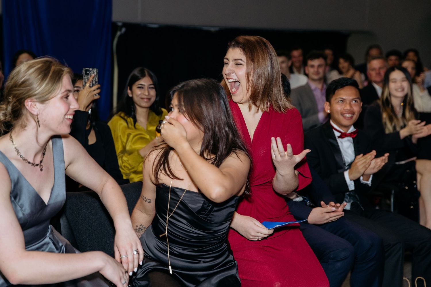 Winners at an awards event reacting with shock an surprise when they are announced as winning
