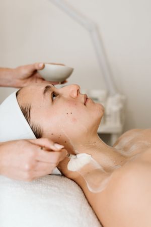Close-up of a relaxing facial treatment being performed in a spa setting.