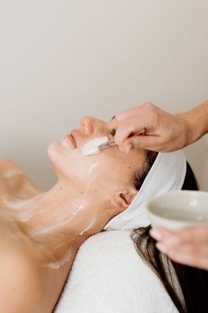 Detailed view of facial mask removal during a professional skincare treatment.