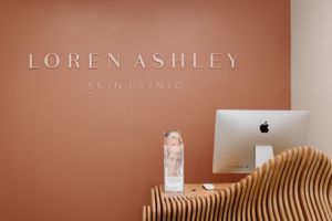 Modern spa interior with coral walls and wooden wave accent decor.