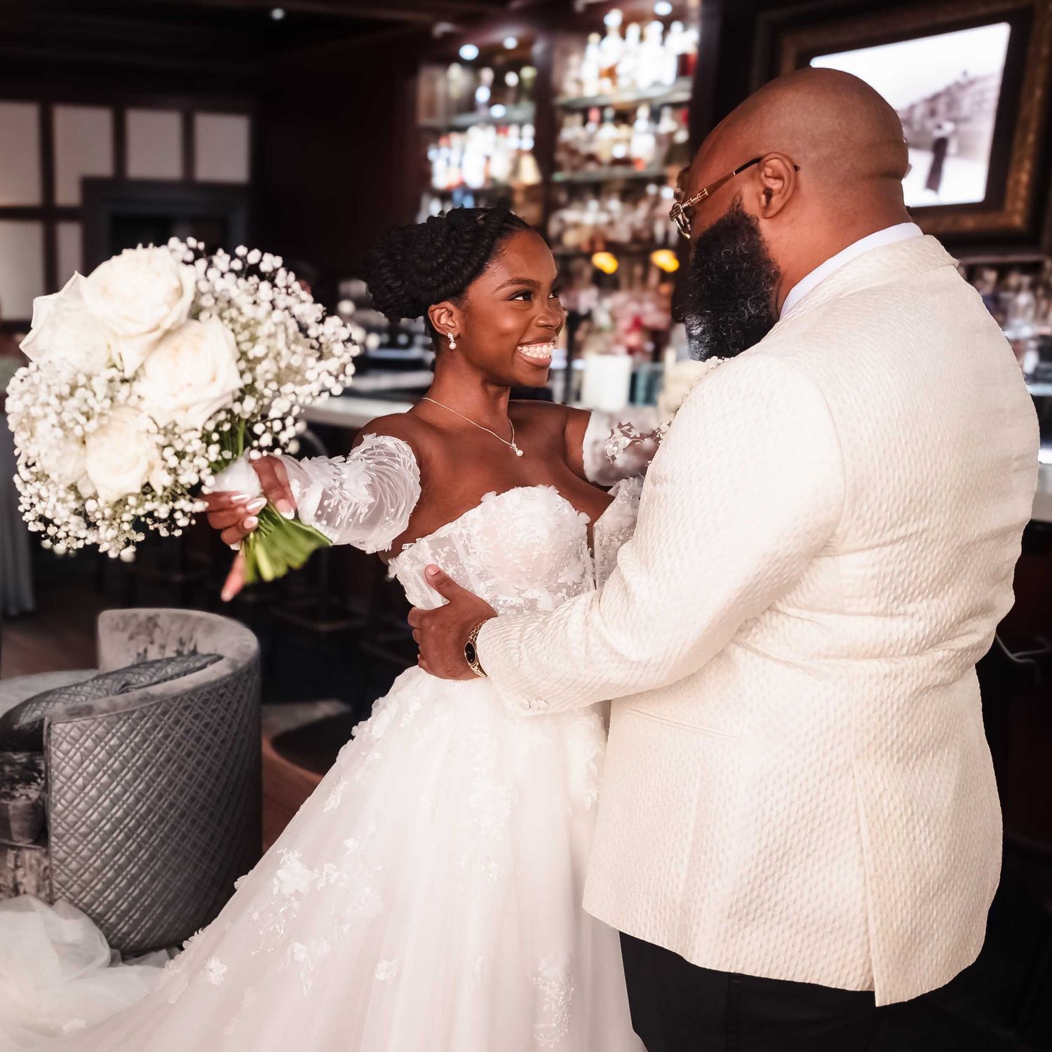 Bride and groom embracing during first look in The Irving tavern at Lenox Hotel Boston with joyful reaction