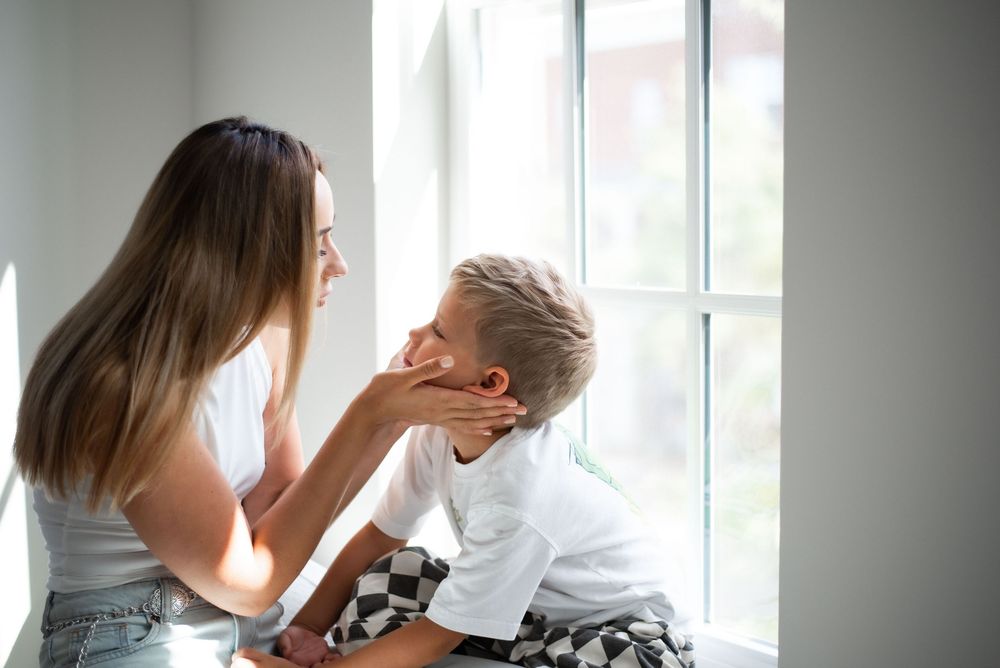 soft natural light portrait mom with son by window Thompson’s Station studio