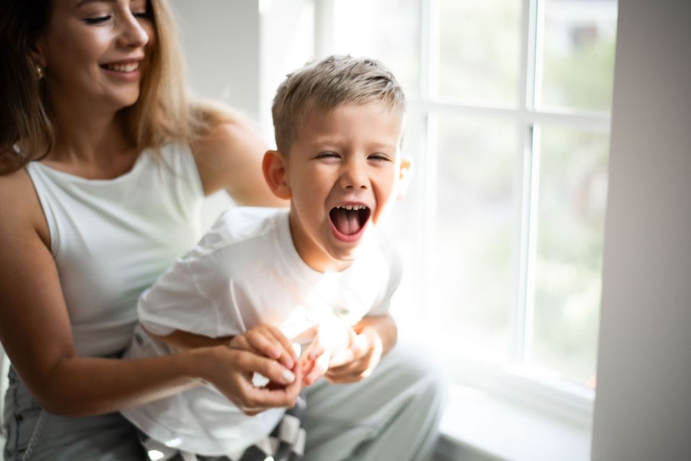 mother holding son by window natural light Thompson’s Station portrait studio