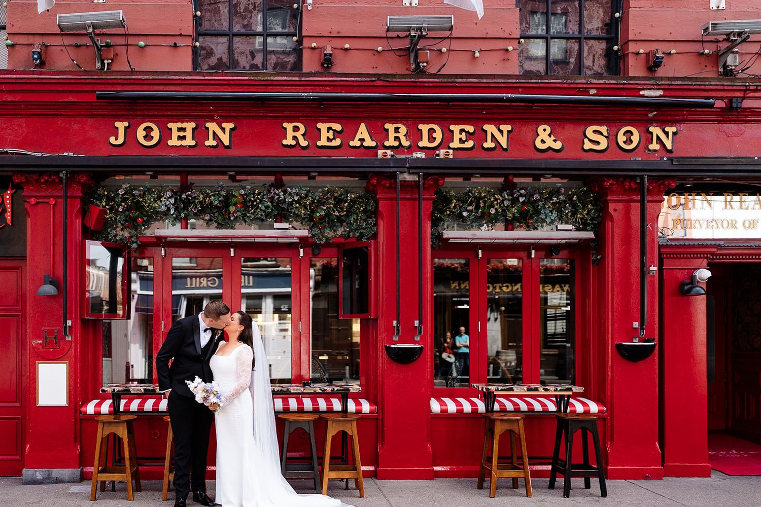 A panoramic view of a red-painted traditional Irish pub, Reardens, in Cork City. Cork Civil Cermony Photos by Sarah Kate photography