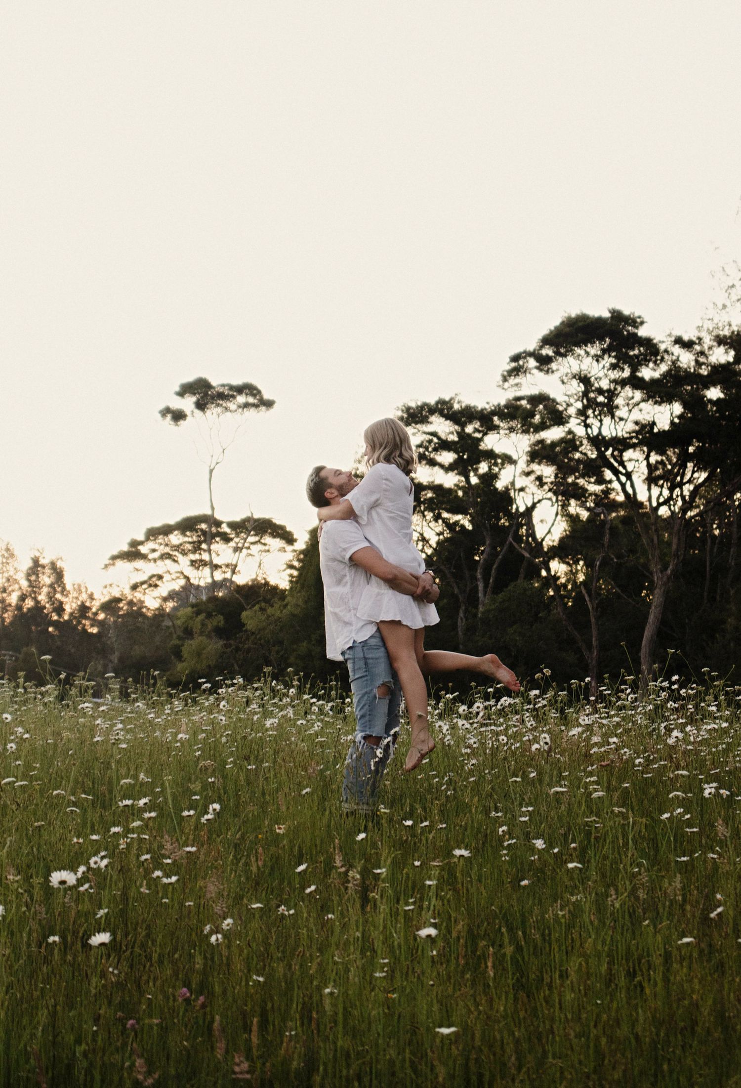 Couple dancing in a field of wild flowers