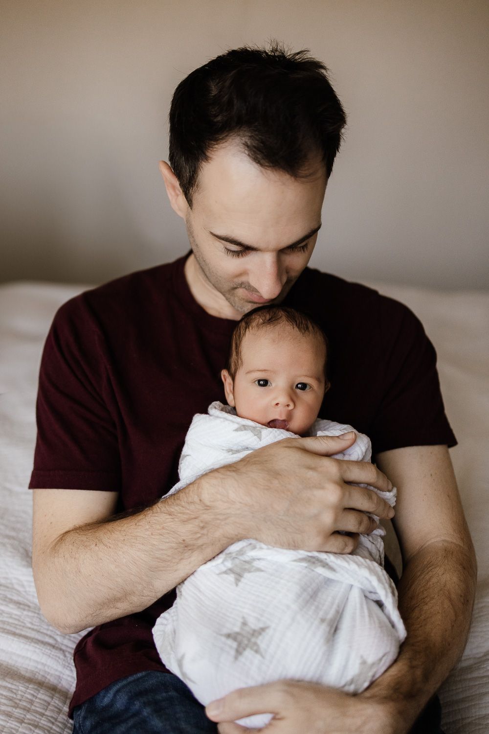 Dad kisses newborn baby's head at San Jose in-home photography session