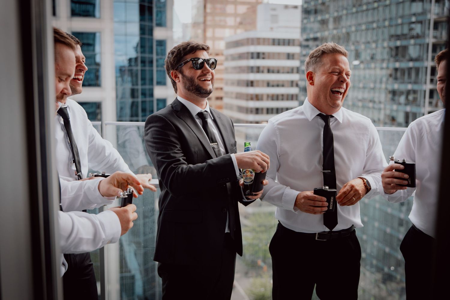 Business colleagues sharing laughs during casual meeting in modern office.