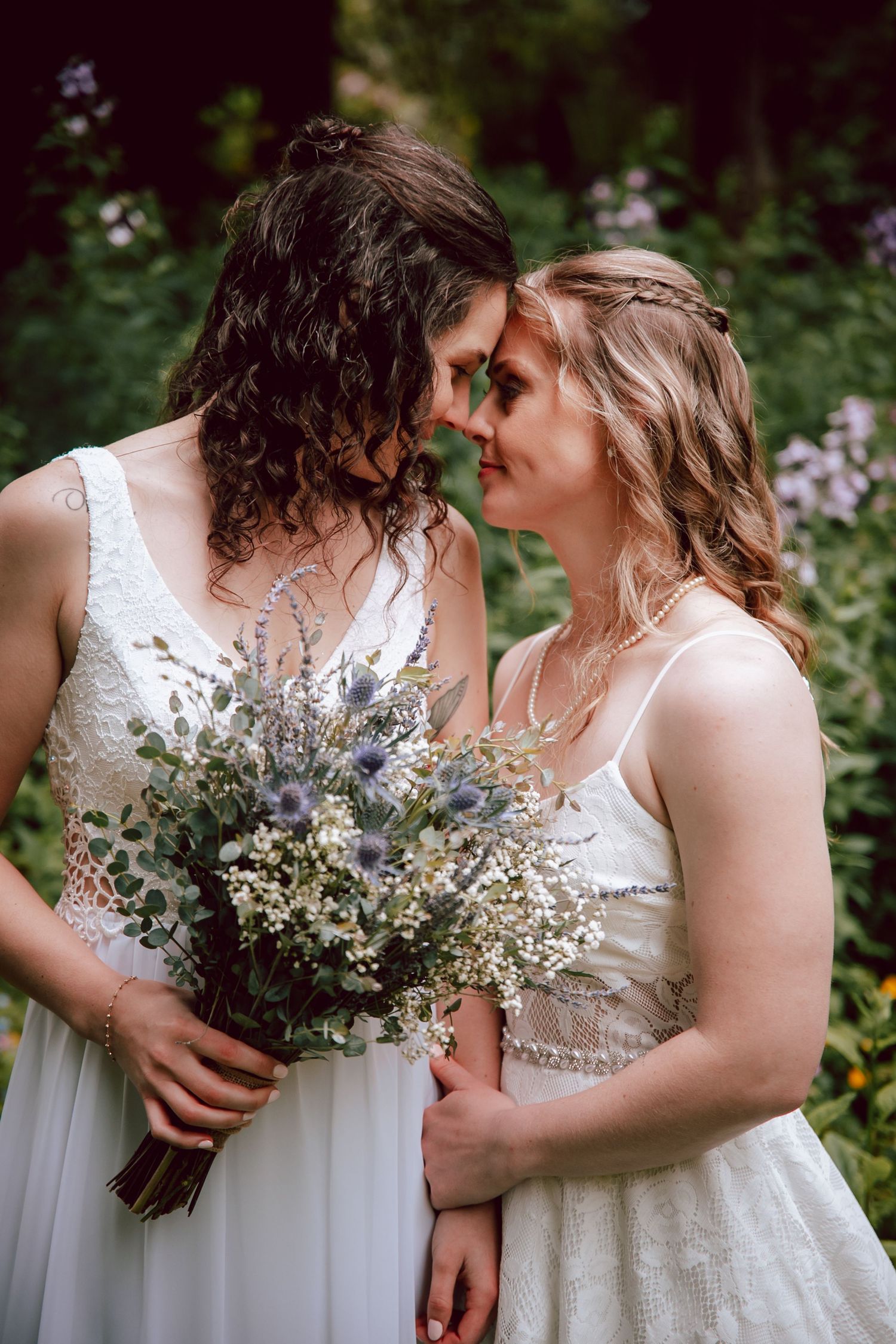 Intimate garden wedding moment with wildflower bouquet featuring dried lavender and baby's breath.