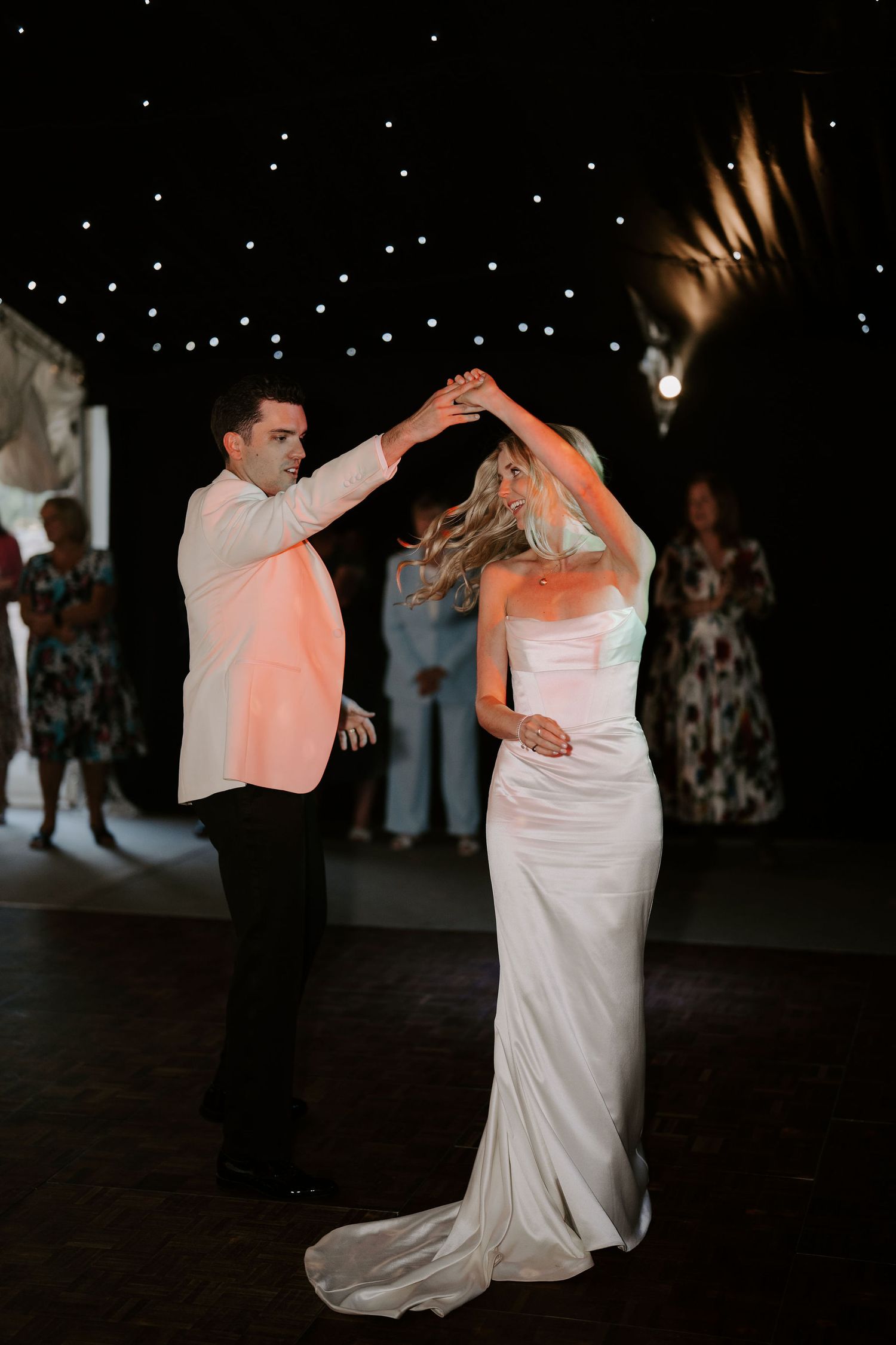 bride and groom doing their first dance surrounded by their wedding guests at hamswell house in bath