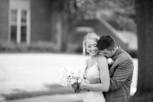 Intimate black and white portrait of newlyweds sharing tender moment.