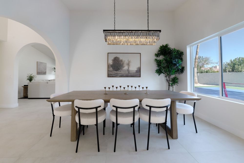 Bright dining area with modern light fixture, black chairs, and large windows overlooking pool.  MLS Photographer, Phoenix Arizona