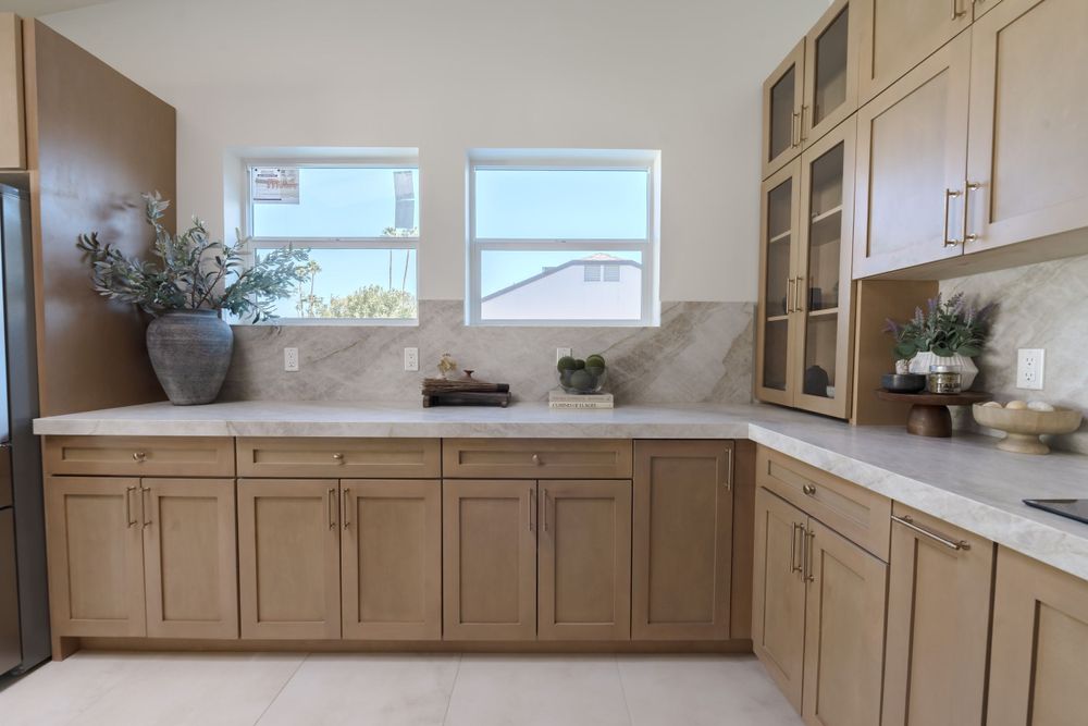 Light wood kitchen cabinets with white countertops and window views in modern design. MLS Photographer, Phoenix Arizona