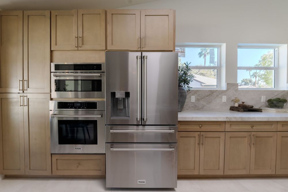Spacious kitchen with stainless steel appliances and light wood cabinetry reaching to ceiling. MLS Photographer, Phoenix Arizona