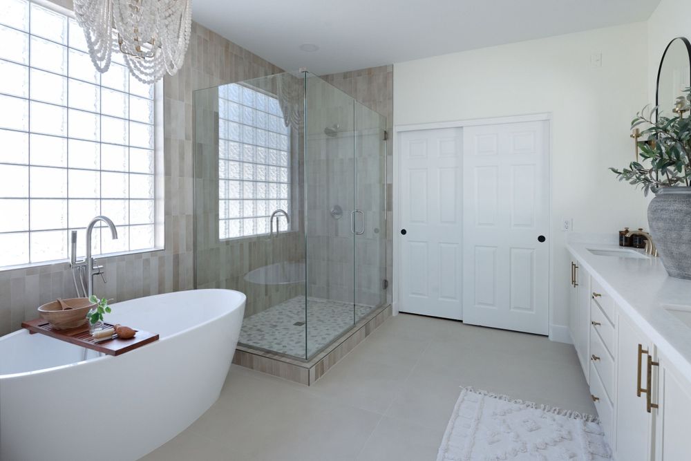 Luxurious bathroom with freestanding tub, glass shower enclosure, and large glass block window. Phoenix Arizona Interior Desing Photographer