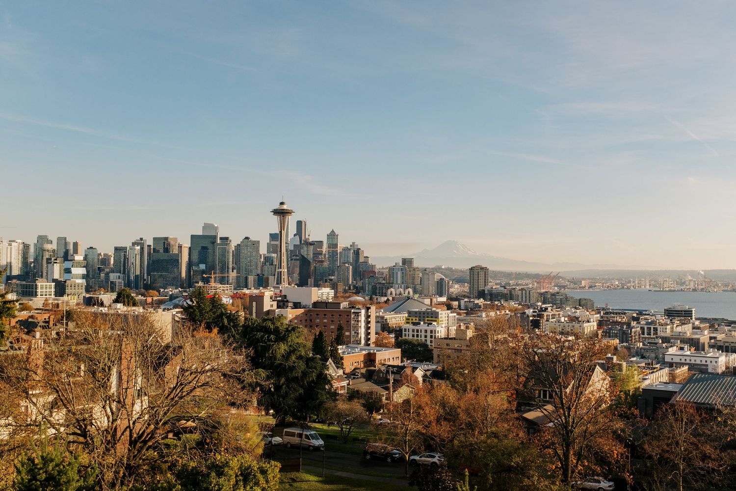 Iconic Seattle skyline with Space Needle viewed from Kerry Park on a clear autumn day with fall foliage in foreground.