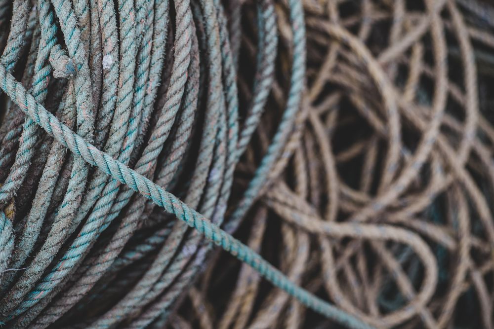 Close-up detail of coiled blue and brown fishing ropes.