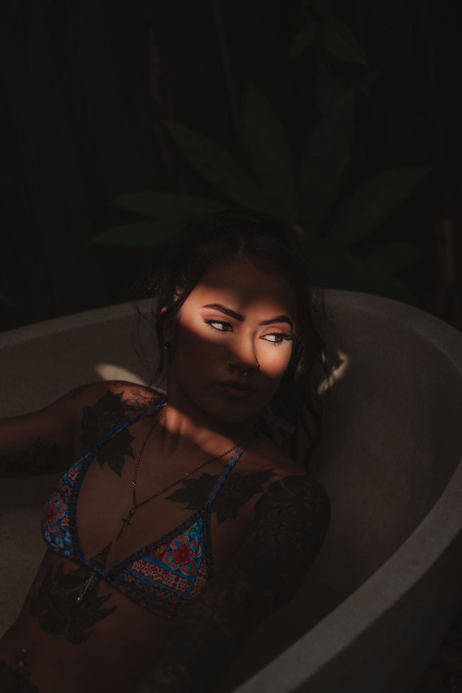 Very dark portrait with light shining over models brown prominent eyes