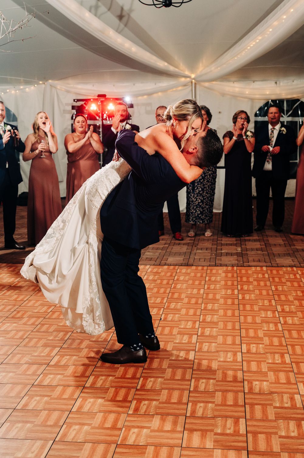 Sequence of a romantic dance dip on a parquet floor at an elegant wedding reception.