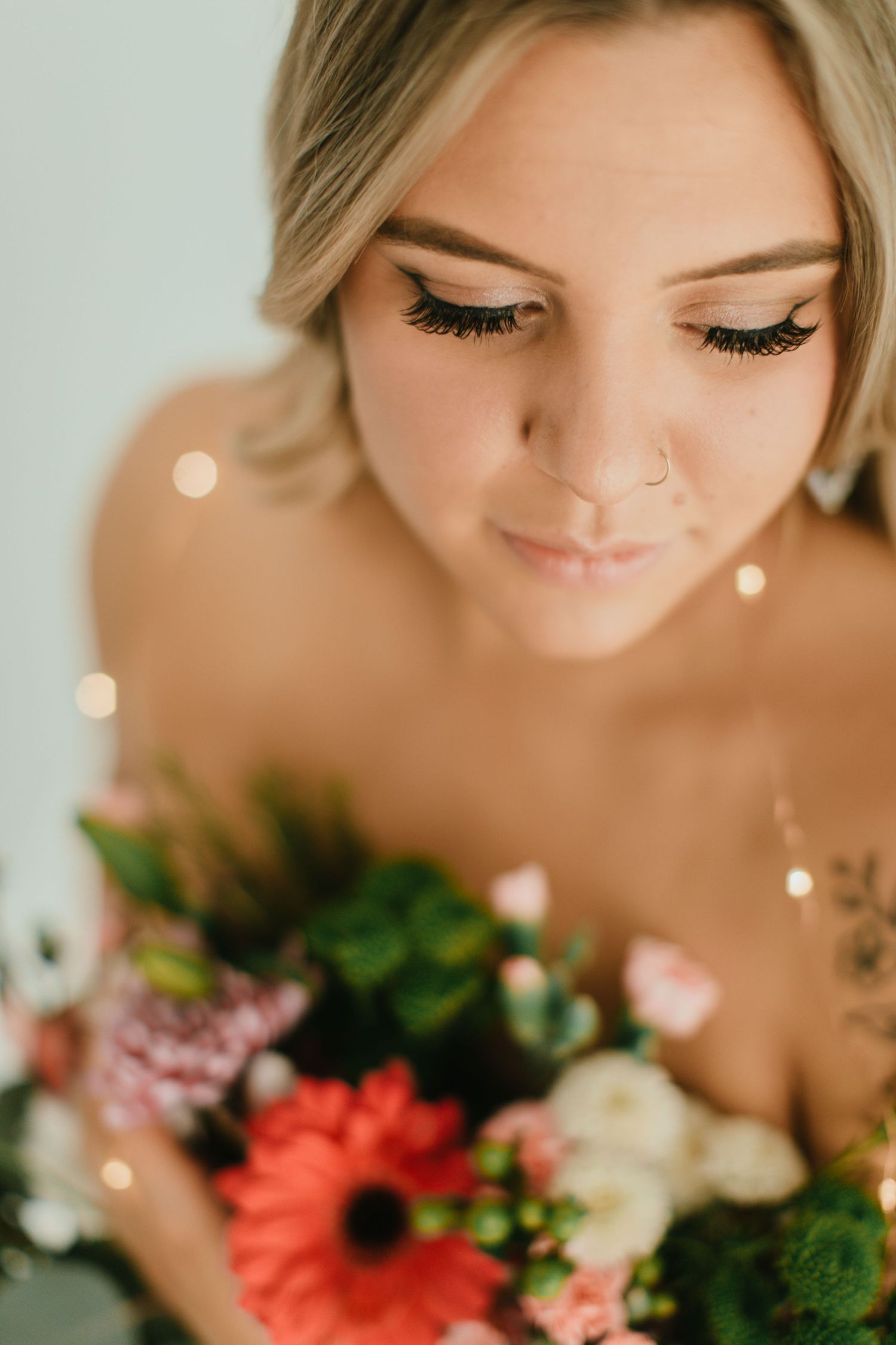Close-up portrait series with floral arrangements and bokeh lighting effects.