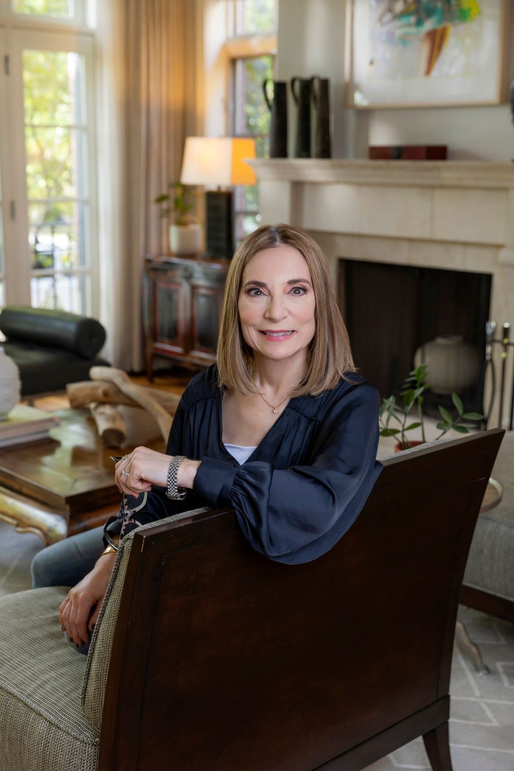 A series of four photos showing someone seated on a dark brown leather couch in a bright, modern living room.