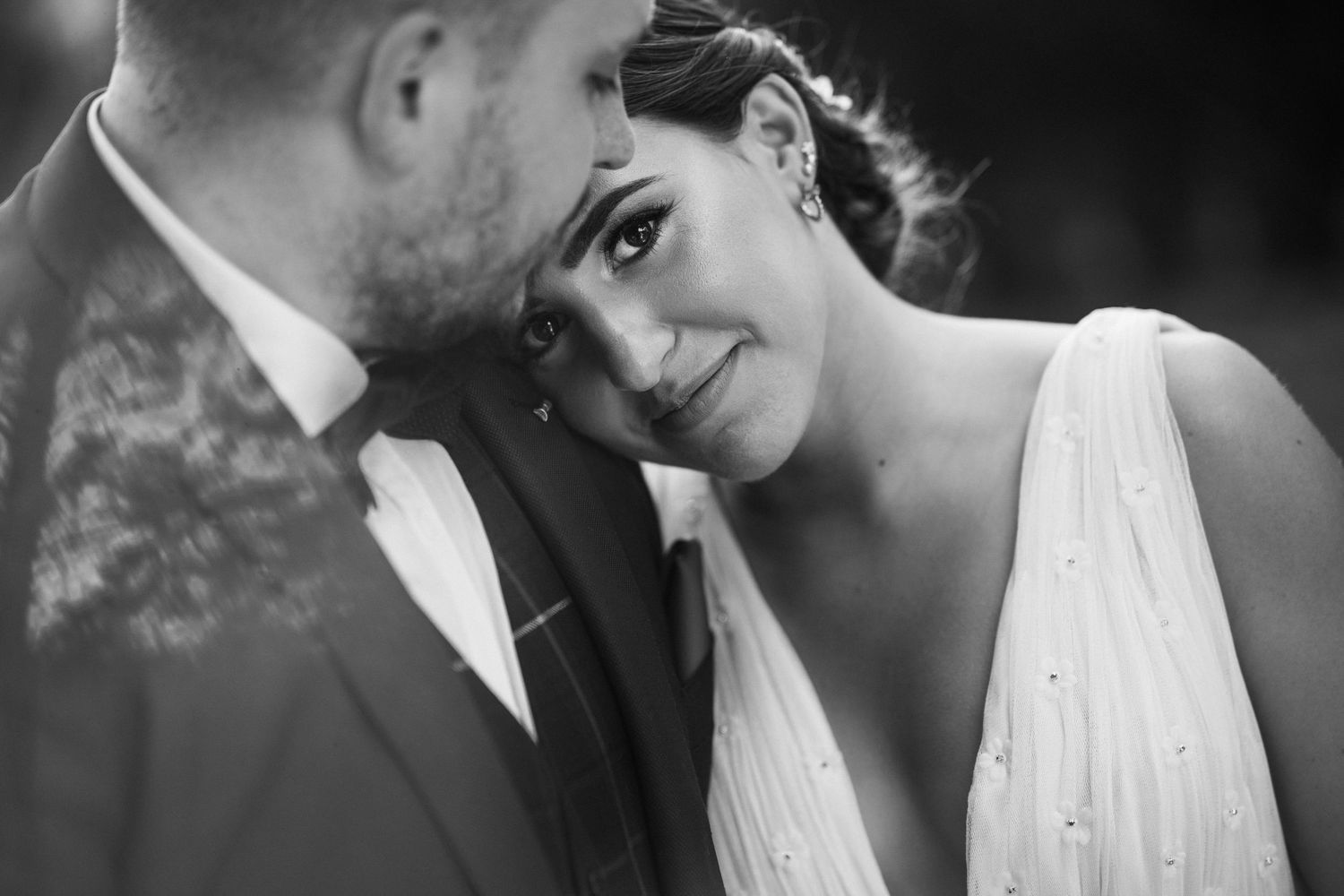 A romantic black and white wedding photo collage showing intimate moments between a bride and groom.